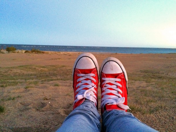 sunrise beach  red sneakers sea